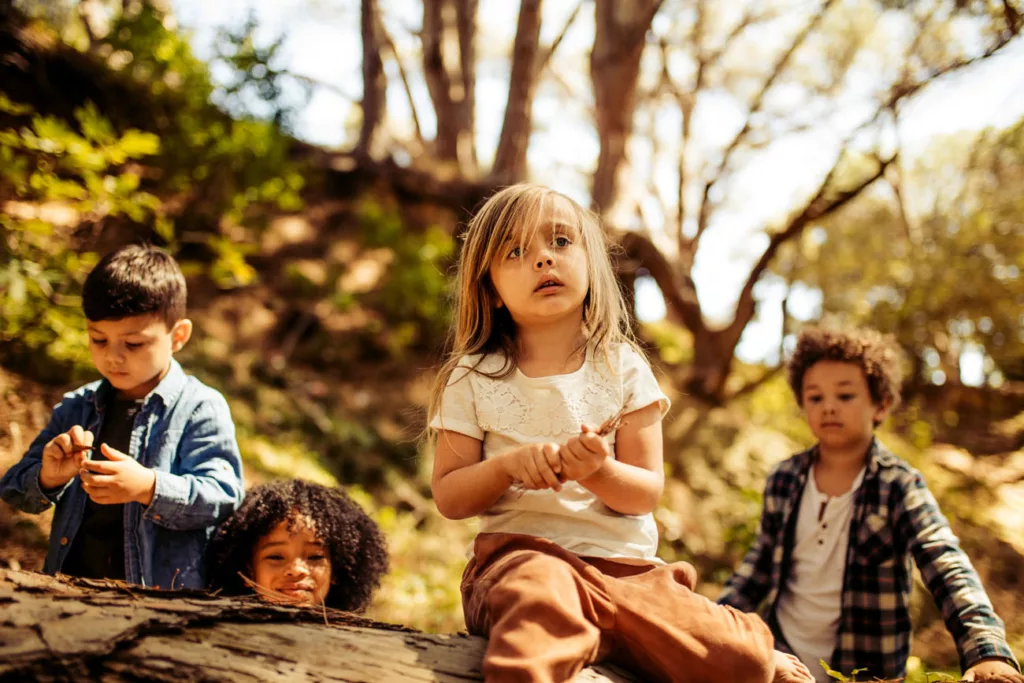 Cute kids playing in forest